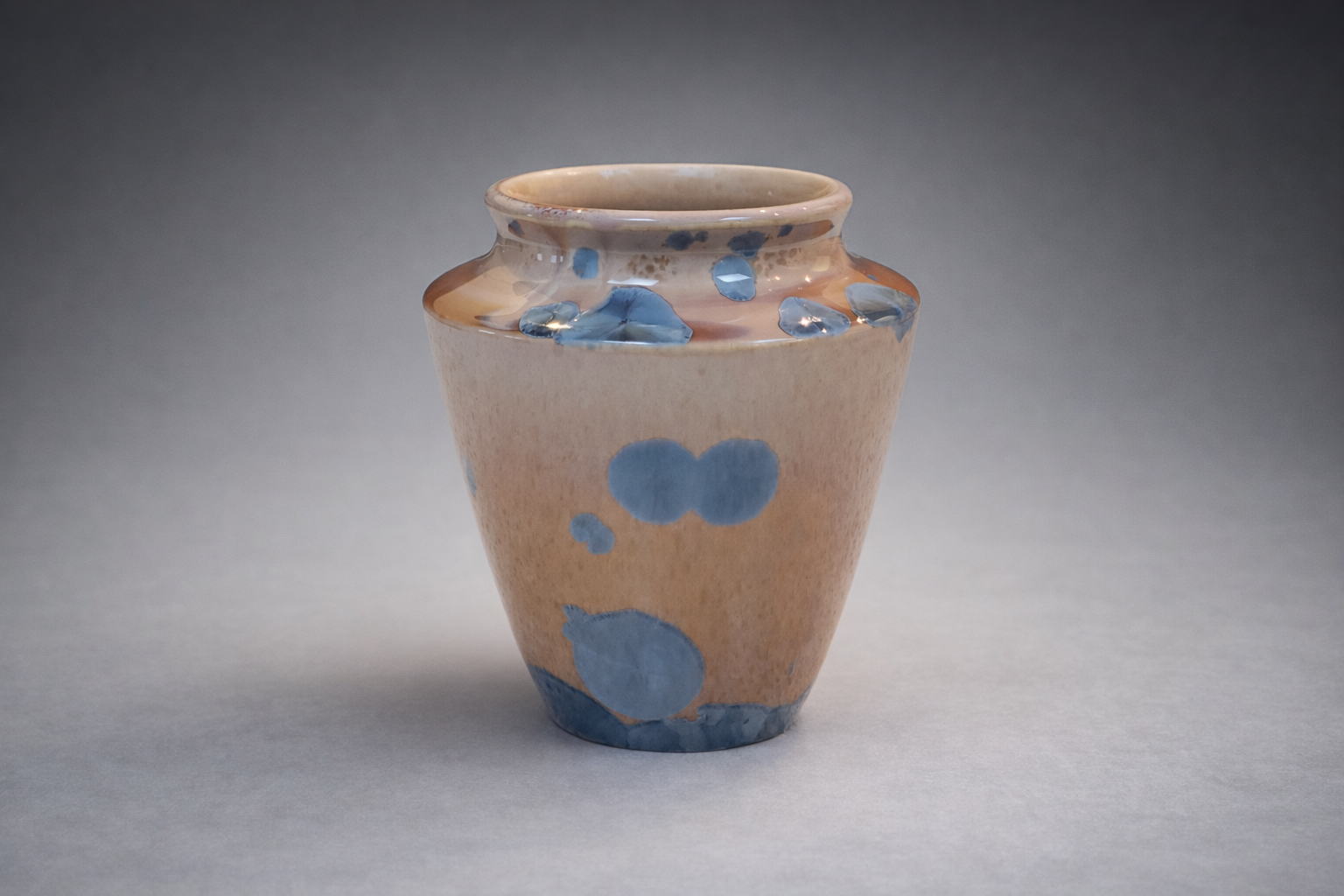 Decorative crystalline glaze vase with soft rounded form and vivid blue crystal patterning