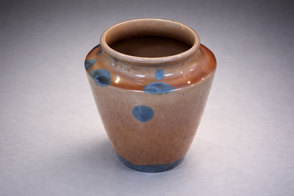 Melbourne handmade pottery vase with amber glaze and striking blue crystalline details