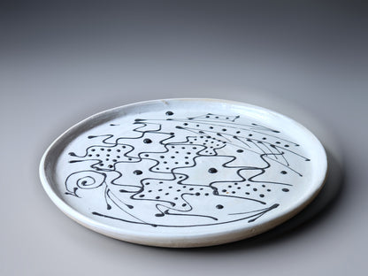 black slip decoration on a handmade pottery plate, made in Melbourne