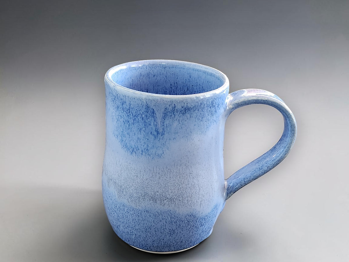 Side image of the blue mottled glaze on handmade ceramic mug