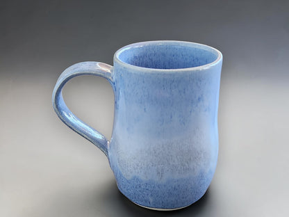 Tall handmade ceramic mug in mottled blue glaze
