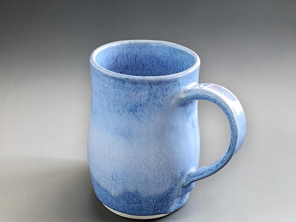 Handmade pottery mug with soft blue mottled glaze