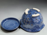 Blue ceramic berry bowl with matching drip tray