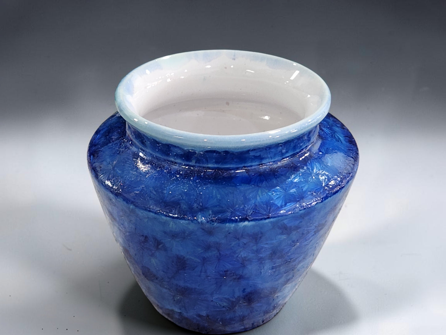 Small blue pottery vase with a wide mouth for fuller flower arrangements