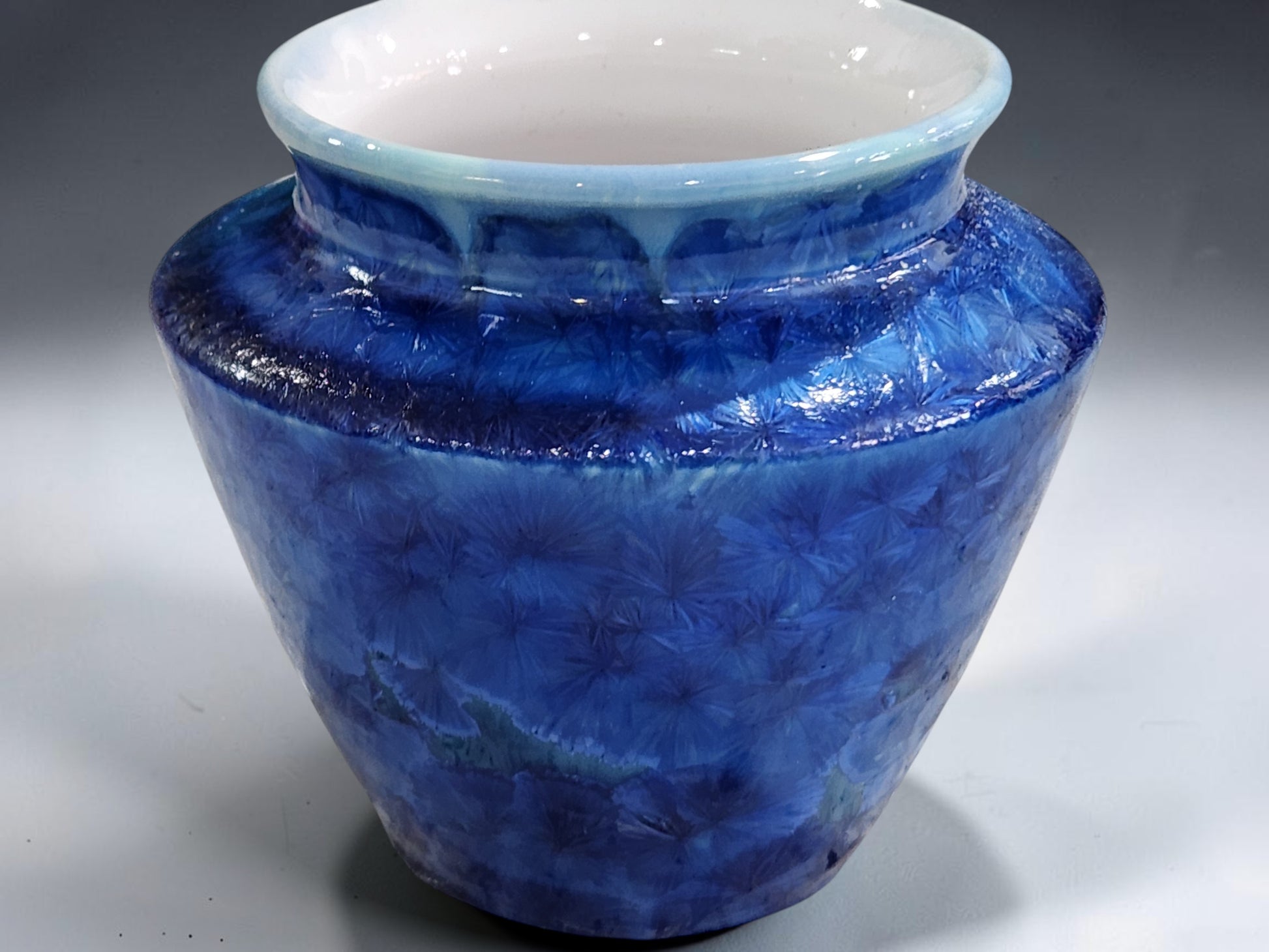 Handmade crystalline vase with rounded body and shaped shoulder