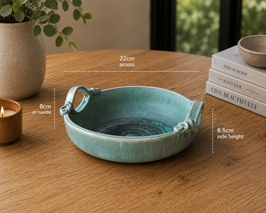 image of handcrafted turquoise ceramic bowl styled on timber table with modern home décor accents