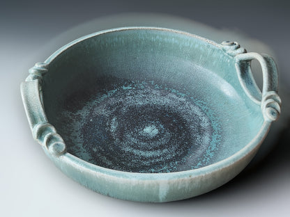 Contemporary pottery serving bowl with soft aqua glaze and handcrafted decorative handles