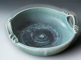 Contemporary pottery serving bowl with soft aqua glaze and handcrafted decorative handles