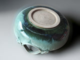 Handcrafted shallow ceramic bowl with looped handles and ocean-inspired glaze detailing