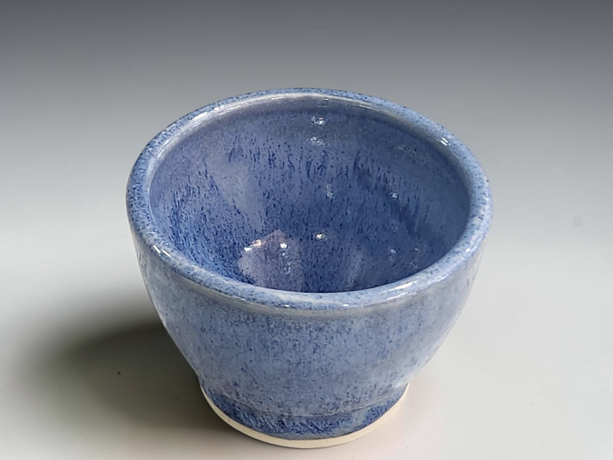 Handcrafted ceramic bowl measuring approximately 8.5cm wide and 6cm high.