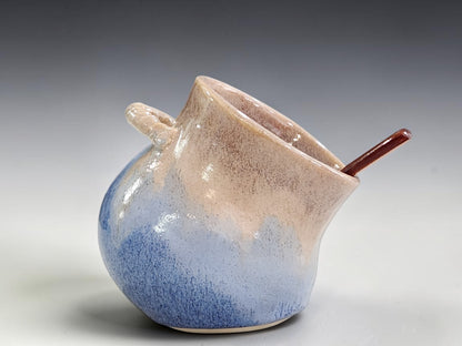 Brown and blue ceramic salt keeper with wooden spoon