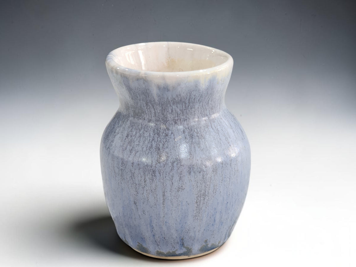Small blue pottery vase with rounded body and flared neck