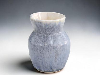 Small blue pottery vase with rounded body and flared neck