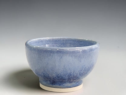 Handmade blue ceramic condiment bowl by Buxton Pottery with mottled glaze and a cream foot.