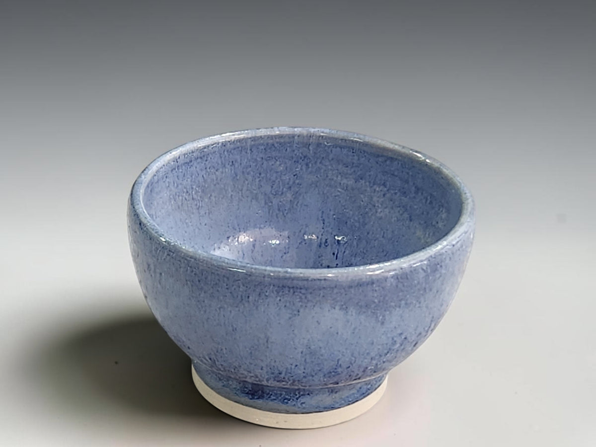 Handcrafted ceramic bowl measuring 8.5cm across and 5cm tall with rounded sides.
