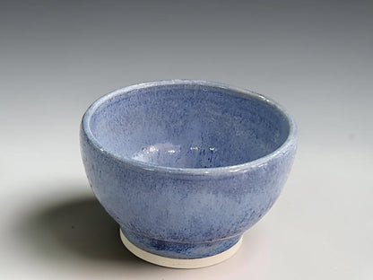 Handcrafted ceramic bowl measuring 8.5cm across and 5cm tall with rounded sides.