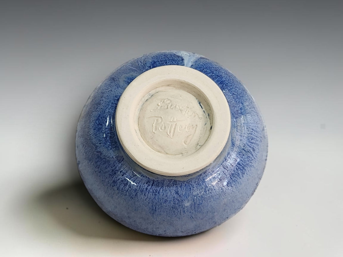Small blue pottery dish with gently flared sides and a thin cream rim.