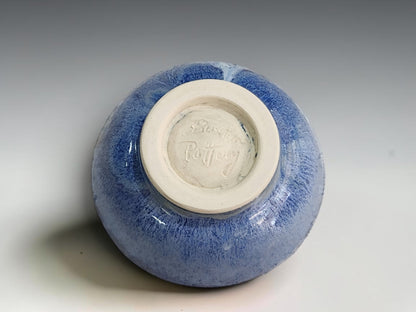 Small blue pottery dish with gently flared sides and a thin cream rim.