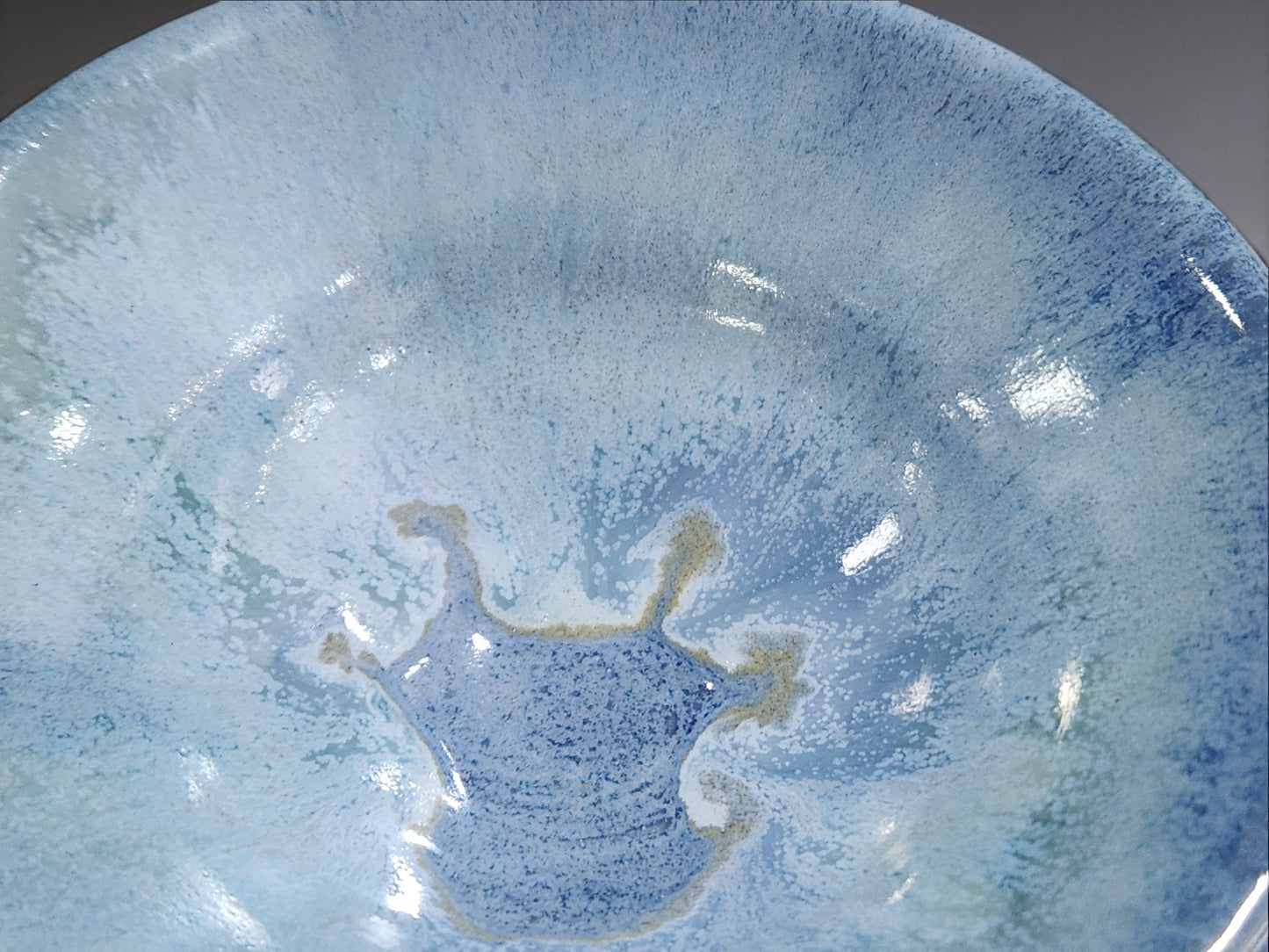 close up of crystalline style glaze handmade ceramic bowl blue tones