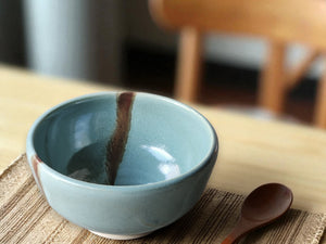 Handmade pottery cereal bowl spearmint green with brown slash