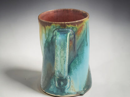 Handmade pottery mug for coffee, tea or hot chocolate with flowing turquoise and earth-toned glaze