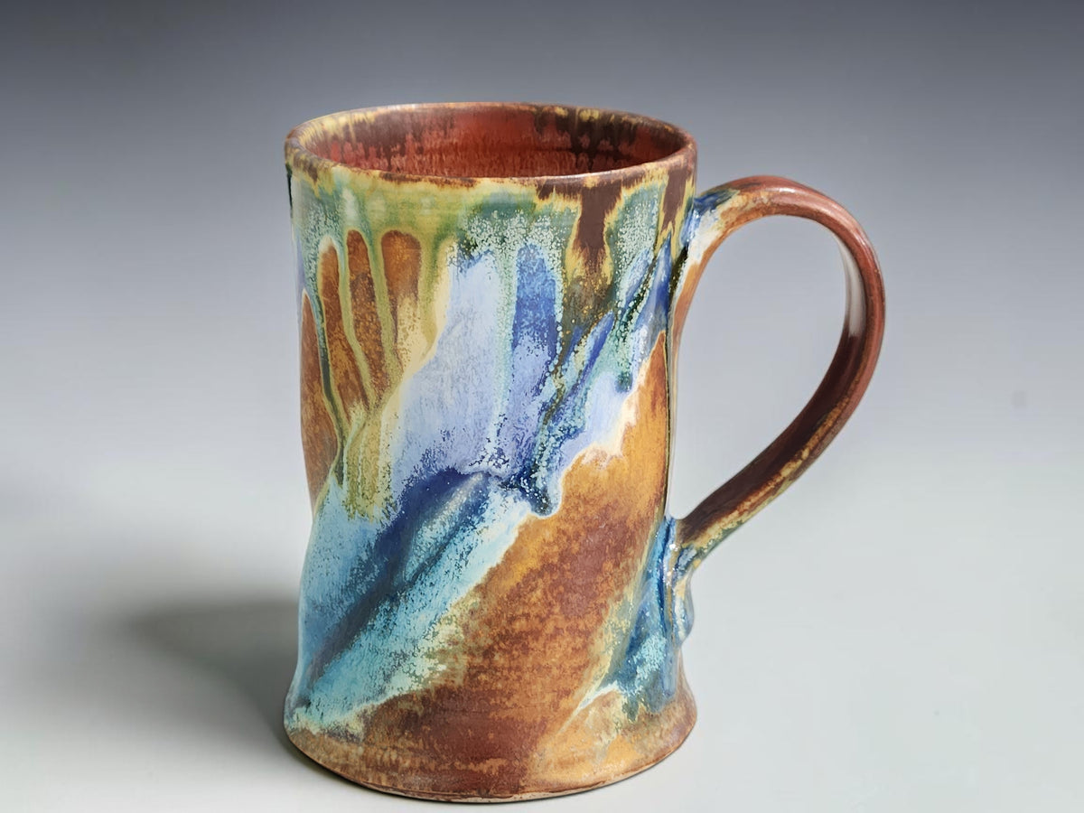 Bush Creek ceramic mug on a timber benchtop beside French press coffee and biscuits.