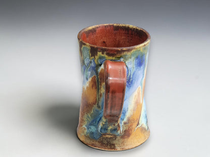 Bush Creek pottery mug featuring muted green, cream and blue glaze details.