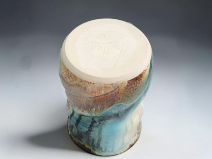 The underside of a Australian handmade pottery mug 400ml with rustic ash glaze and comfortable shaped form with the makers mark
