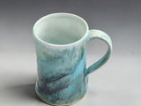 Handmade pottery mug with satin interior and blue green glaze detail