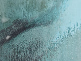 close up of a Handmade ceramic tea mug with soft turquoise and jade glaze finish
