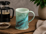 Hero image of Bush Creek Mist ceramic mug styled with French press coffee