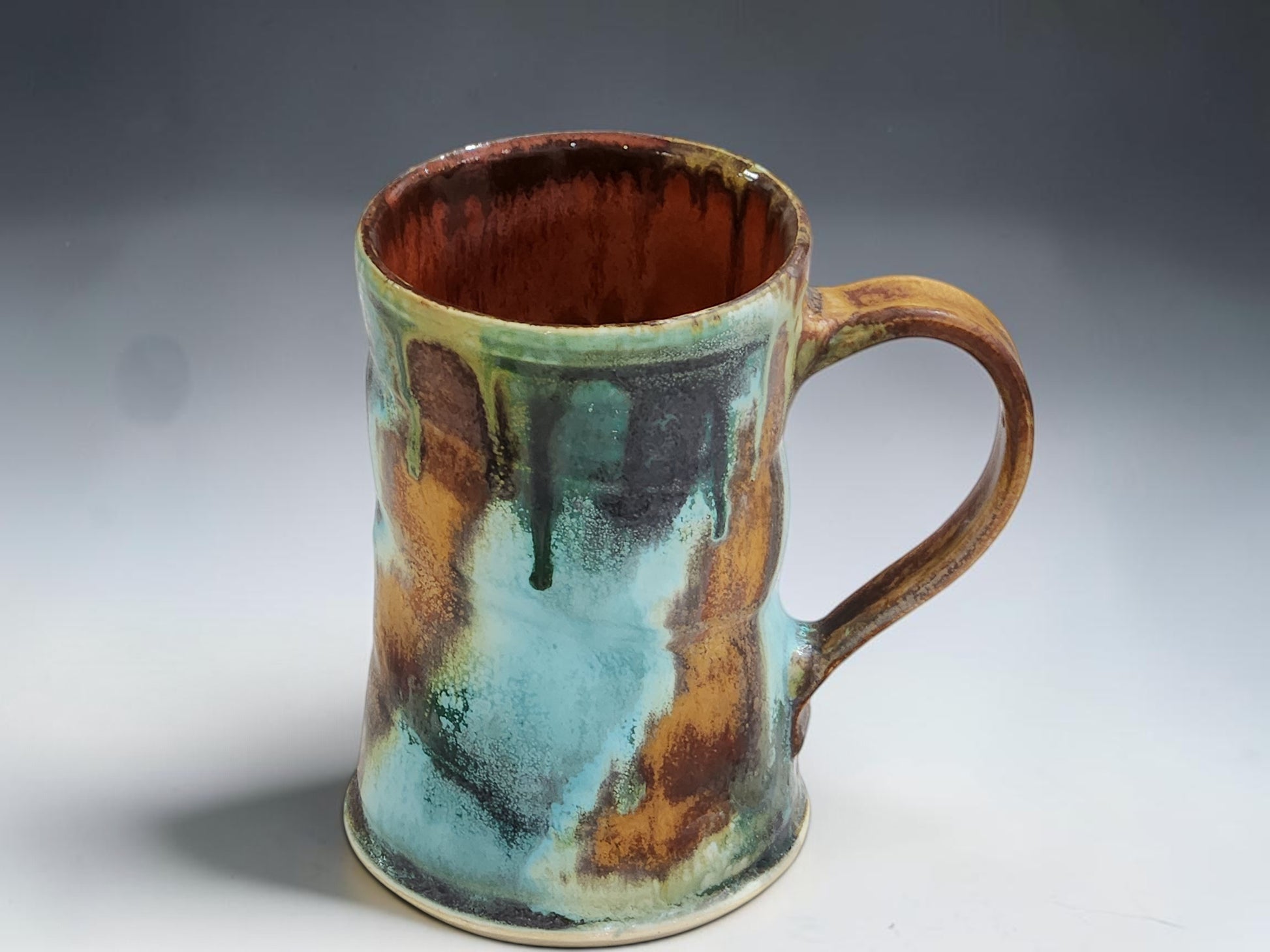 Handmade pottery mug with red brown interior glaze, crafted by Buxton Pottery in Melbourne Australia