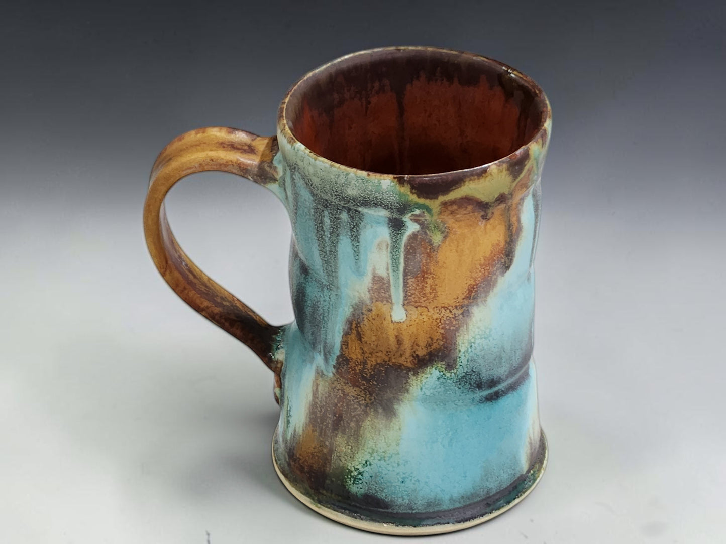 Wheel-thrown ceramic coffee mug with comfortable handle and one-of-a-kind handmade glaze