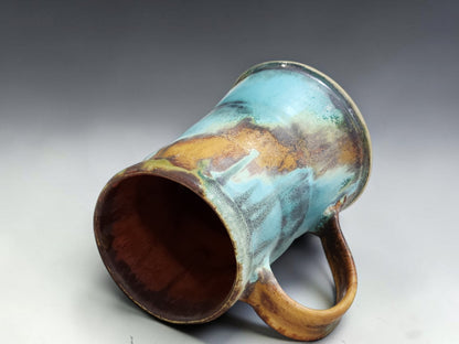 Buxton Pottery handmade mug with red brown interior and layered Bush Creek exterior glaze