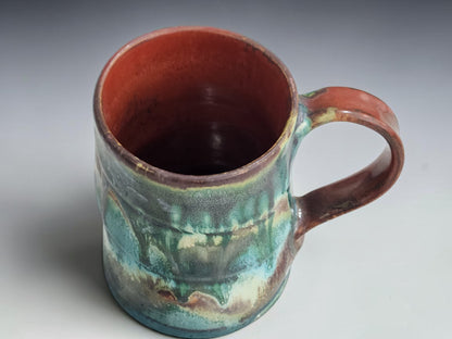 Front view of the Bush Creek mug showing layered green and cream glaze patterns.