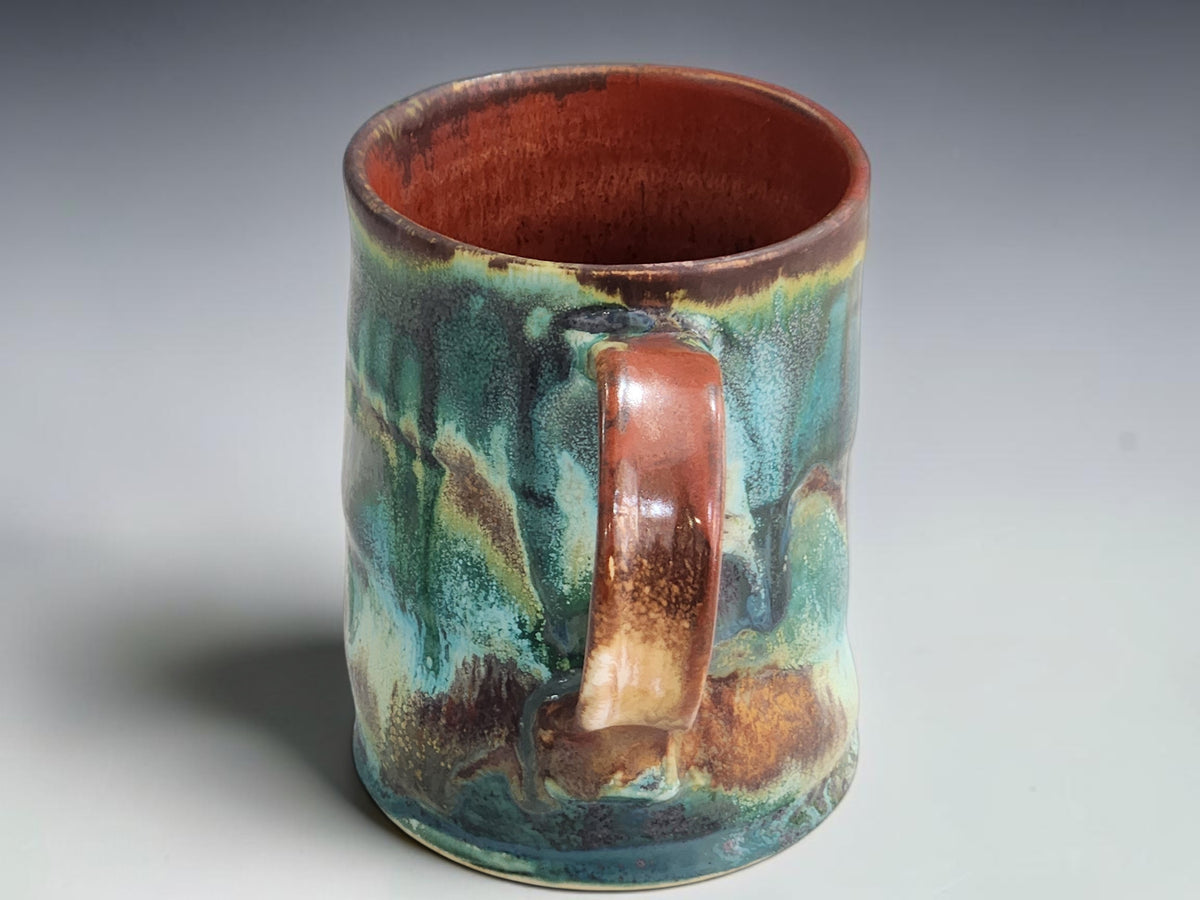 Bush Creek ceramic mug styled with biscuits and a linen napkin on timber.