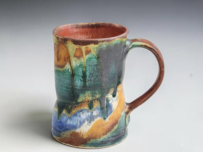 Handmade Bush Creek 300ml pottery mug with turquoise, green and earthy brown glaze.