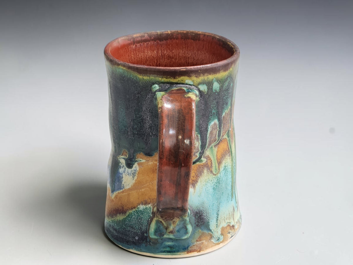 Buxton Pottery 300ml mug with a dark brown rim and gently flared base.