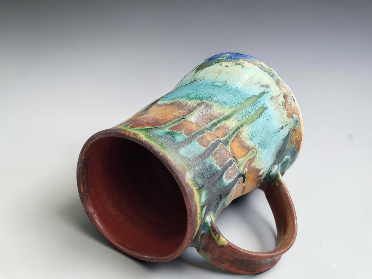 Handmade ceramic coffee mug measuring 11.5cm tall and 8cm across the base.