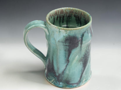 Large handmade ceramic coffee mug with soft green glaze and organic handmade shape