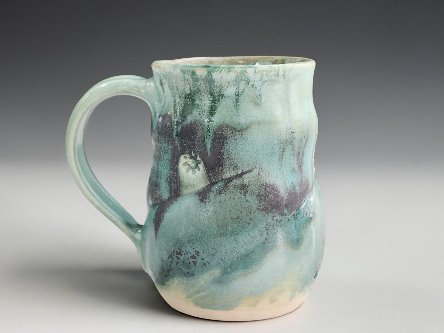 Handmade stoneware mug with flowing seafoam green glaze, crafted by Buxton Pottery in Melbourne Australia