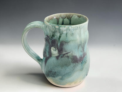 Large handmade ceramic coffee mug with soft green glaze and organic handmade shape