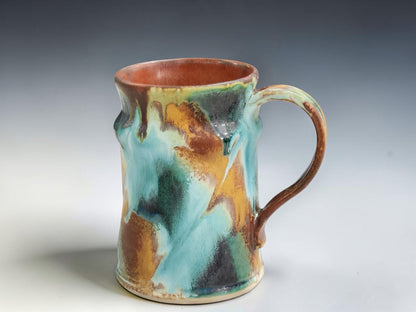 Handmade stoneware mug with flowing turquoise, rust and green glaze, crafted by Buxton Pottery in Melbourne Australia