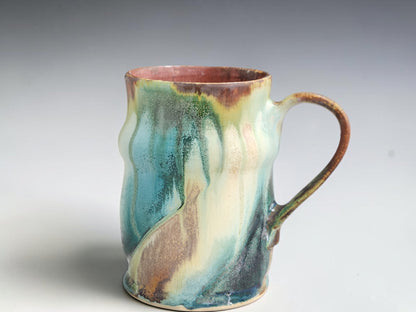 Handmade Bush Creek 400ml pottery mug with flowing turquoise, cream and earthy brown glaze.