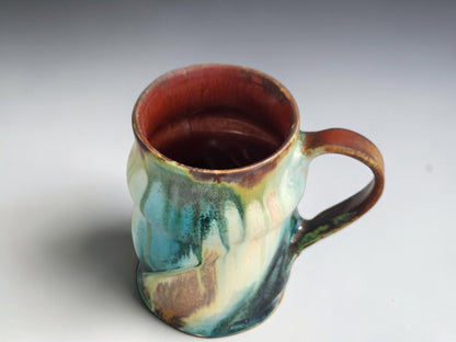 Top view of mottled turquoise and dark green glaze on a Bush Creek mug.