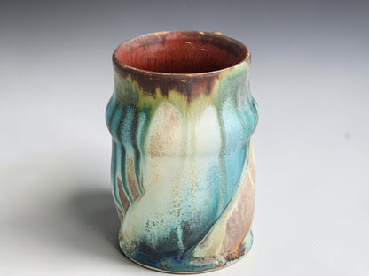 Front view of a Bush Creek mug showing a sweeping cream glaze pattern.