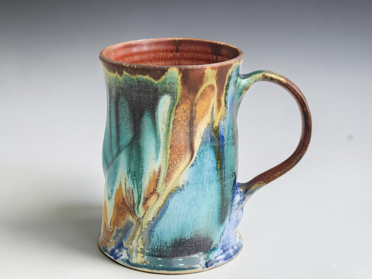 Handmade Bush Creek 325ml pottery mug with turquoise, forest green and earthy brown glaze.