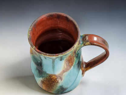 Handmade stoneware mug with flowing aqua, rust and green glaze, crafted by Buxton Pottery in Melbourne Australia