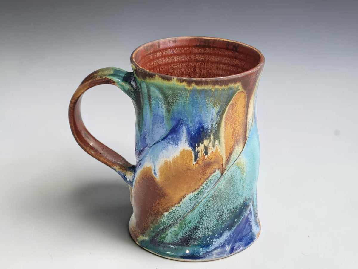 Handmade 325ml ceramic coffee mug measuring 11.5cm tall and 8.5cm across the base.