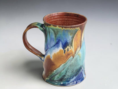 Handmade 325ml ceramic coffee mug measuring 11.5cm tall and 8.5cm across the base.